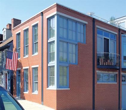 Proportion and materials tie the new modern facade to its historic neighborhood. 