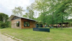 Designed+and+built+by+Rural+Studio+students+in+Newbern%2c+Ala.%2c+the+town+hall+is+built+out+of+stacked+timbers.+Sourced+locally%2c+the+cypress+beams+were+squared+at+8+inches+by+8+inches+and+are+held+together+with+a+%c2%bd-inch+threaded+rod.