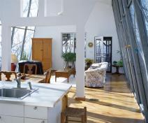 The design team controlled expenses by using off-site prefabrication, drywall, and IKEA cabinetry and countertops.