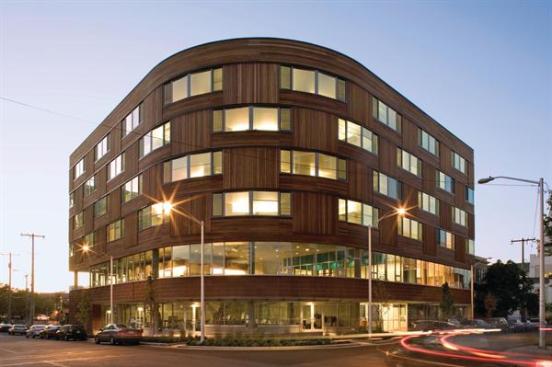 Ground-floor commercial space is topped by second-story common areas, with residences for cancer care patients taking up the upper levels.