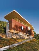 An inviting mix of black lueders limestone and ipe greet visitors as they approach the Austin, Texas, home.