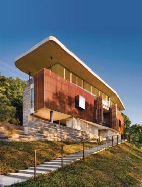 An inviting mix of black lueders limestone and ipe greet visitors as they approach the Austin, Texas, home.