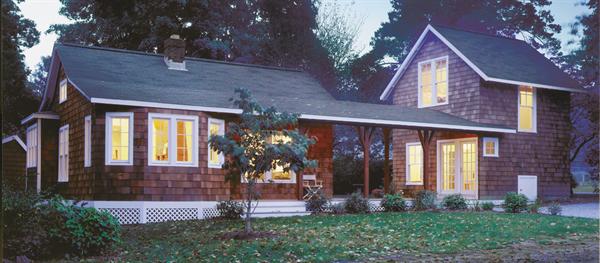 A covered boardwalk connects the remodeled main house to a new, two-story guest cottage.