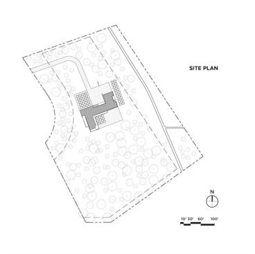 Site plan. The steel-clad residence sits on 8 acres of heavily wooded terrain