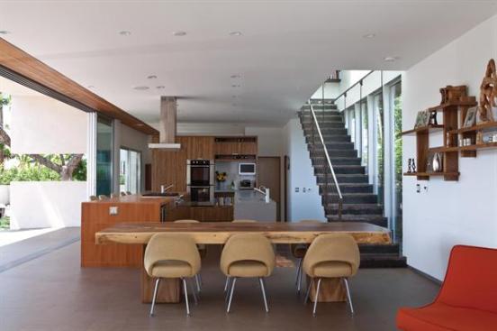 With upper cabinets limited to a single end wall, the kitchen opens to light and views along its two outside walls.