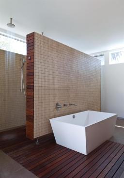 A floating partition shields the shower and toilet areas.