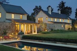 A fieldstone wall links the main house (right side) and guesthouse of this rural Piedmont property and defines an edge of the rear gardens.