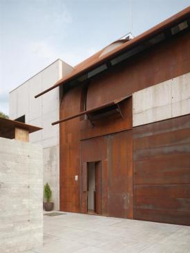 The entry facade is clad in Cor-Ten steel.