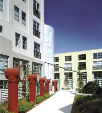 Formerly a brewery, this structure was reused for a condo project. The brewery's roasting drums were converted into exterior light fixtures, while one of the two remaining grain silos is now part of a plume that carries water to a fountain.