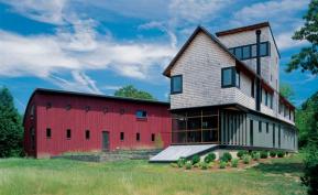 Three traditional building forms a gable-roofed main house, a shedlike studio, and a saltbox-style loft come together in an unexpected fashion.