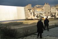 Ferretti leads a MoMA curator on a tour of the set he designed for Martin Scorcese's Gangs of New York.