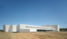 Polygonal perforations, abstracted from the building’s hexagon-based design, cascade across the exterior of the Contemporary Art Center in Córdoba, Spain, allowing natural light to dapple its interior.