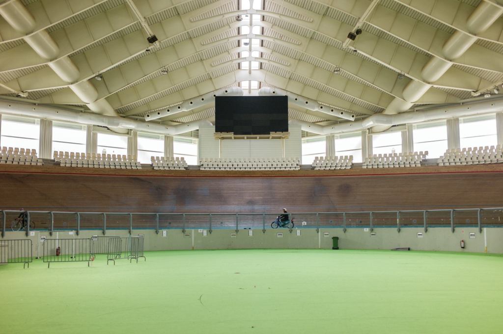 Athens 2004

An outdoor concrete track built in 1991, this 5,200-seat facility reopened for the 2004 Games, after an extensive renovation by Santiago Calatrava, FAIA. The venue for track cycling events, it features a 250-meter banked track covered in Afzelia wood and a retractable roof supported by steel cables affixed to two swooping arches—structures that recall Calatrava’s Zubizuri footbridge in Bilbao, Spain. Many facilities in the Athens Olympics Sports Complex have fallen into disrepair, but the Velodrome remains in frequent use on the European track cycling circuit.
