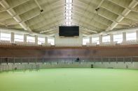Athens 2004

An outdoor concrete track built in 1991, this 5,200-seat facility reopened for the 2004 Games, after an extensive renovation by Santiago Calatrava, FAIA. The venue for track cycling events, it features a 250-meter banked track covered in Afzelia wood and a retractable roof supported by steel cables affixed to two swooping arches—structures that recall Calatrava’s Zubizuri footbridge in Bilbao, Spain. Many facilities in the Athens Olympics Sports Complex have fallen into disrepair, but the Velodrome remains in frequent use on the European track cycling circuit.