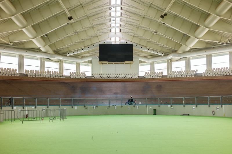 Athens 2004

An outdoor concrete track built in 1991, this 5,200-seat facility reopened for the 2004 Games, after an extensive renovation by Santiago Calatrava, FAIA. The venue for track cycling events, it features a 250-meter banked track covered in Afzelia wood and a retractable roof supported by steel cables affixed to two swooping arches—structures that recall Calatrava’s Zubizuri footbridge in Bilbao, Spain. Many facilities in the Athens Olympics Sports Complex have fallen into disrepair, but the Velodrome remains in frequent use on the European track cycling circuit.