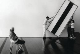 Dominique de Menil oversees workers as they hang a painting by Barnett Newman in the Menil Collection museum.