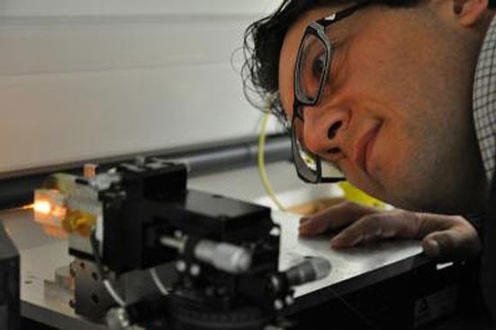 Dr. Gilberto Brambilla peering at a silicon nanofiber.
