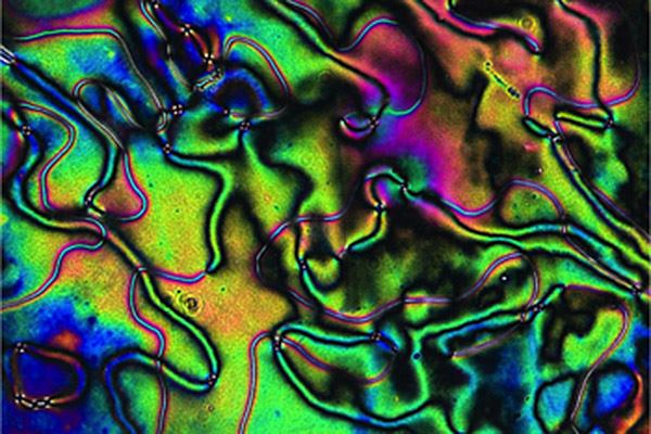 A liquid crystal form of silicone which toughens under compression.