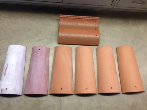 Student researchers at the University of California, Riverside developed an air-cleaning, titanium-dioxide coating for ceramic tiles shown on two tiles (far left). Uncoated tiles are shown to the right and, at top, a commercially available tile with a titanium dioxide coating.