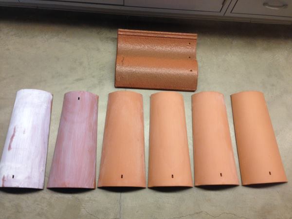 Student researchers at the University of California, Riverside developed an air-cleaning, titanium-dioxide coating for ceramic tiles shown on two tiles (far left). Uncoated tiles are shown to the right and, at top, a commercially available tile with a titanium dioxide coating.