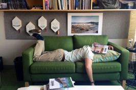 Associate design editor Deane Madsen, Assoc. AIA, tries to get comfortable on one of ARCHITECT's office couches.