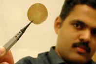 Rahul Nair, who is researching a novel graphene-oxide coating at the University of Manchester, in the U.K., displays a one-micron-thick graphene-oxide membrane.