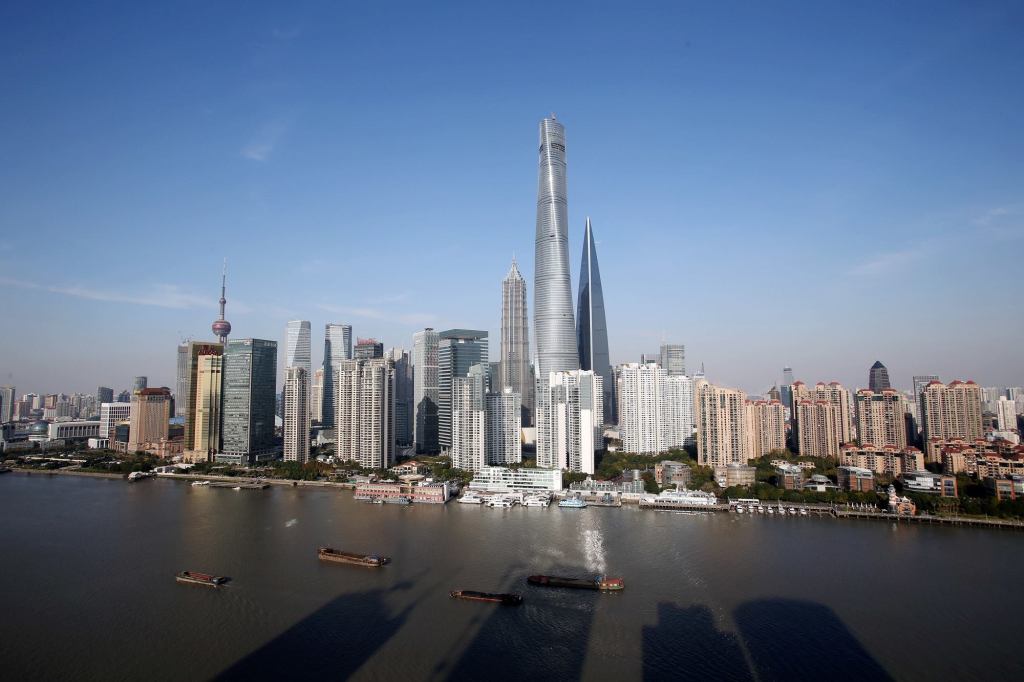 The skyline of the Lujiazui Financial District showing the Shanghai Tower, the tallest skyscraper in the middle, added. The tower is now under construction next to the Shanghai World Financial Center, right, as well as the Jinmao Tower and other skyscrapers and high-rise buildings in Shanghai. Construction is scheduled to finish in December, when the last tower crane is torn down and an eddy current damper is installed. Estimated to start official operation in mid-2015, the tower will carry out equipment testing and closeout decoration in the coming months.