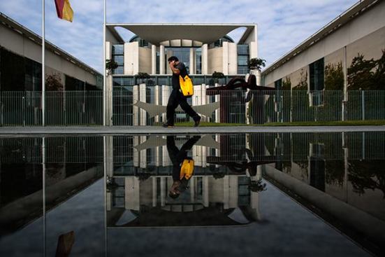 A man walks past the federal chancellery in Berlin on June 4. The 2001 building was designed by Berlin-based Schultes Frank Architekten.