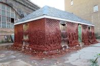 The partiallly melted wax house, which includes deteroriating windows and a warped door, as part of the music and arts festival MERGE in London.