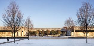 The main entrance, with its grove of trees. View from the west.