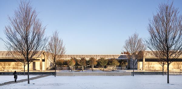 The main entrance, with its grove of trees. View from the west.