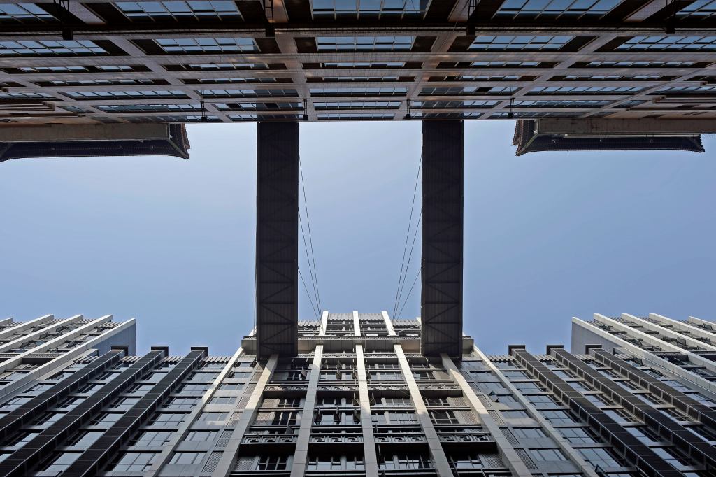 Two pedestrian bridges stick out from the 22nd story of a building at the height of 68.5 meters (225 feet), providing people with a shortcut to the opposite building in minutes, in Southwest China's Chongqing municipality. The construction company said the two bridges were elevated by a 150-ton crane and fixed on the external wall of a building on one side.