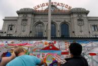 DENVER, CO - JULY 26: Visitors are encouraged to paint on a paper mural outside the station. Denver Union Station hosts a public event for their grand opening celebration featuring food trucks and live music on Wynkoop Street and free tours of the building. (Photo by Kathryn Scott Osler/The Denver Post)