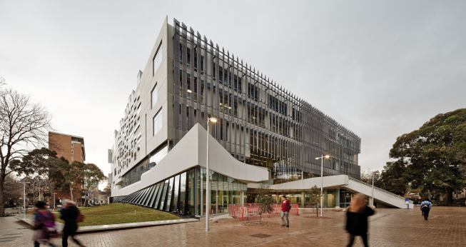 The new architecture school building fronts a quad at the University of Melbourne; a façade clad in Bianco Precast concrete panels overlooks an adjacent greenspace.