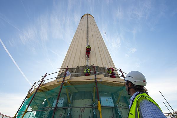 Work begins to remove the four chimneys from London's Battersea Power Station, which will then be rebuilt.