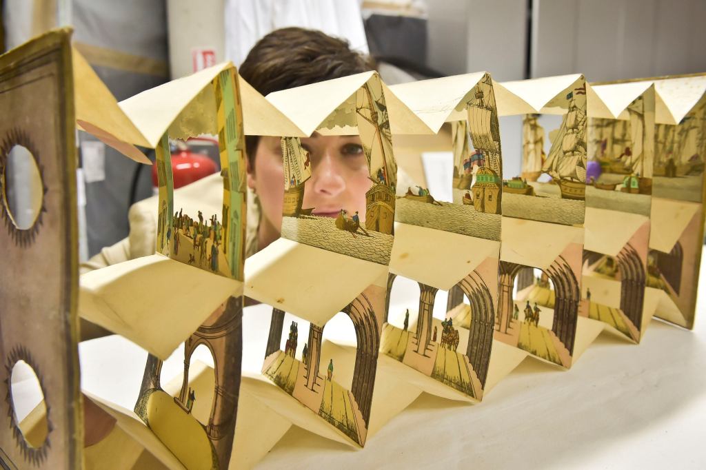 Rhian Tritton, the director of education and conservation at the ss Great Britain in Bristol, England, looks at a peep show item of the Thames Tunnel. The item is part of an exhibition on the work of the engineer Isambard Kingdom Brunel slated to open in 2016.
