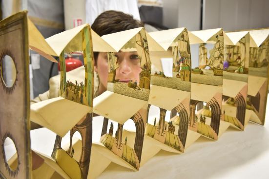 Rhian Tritton, the director of education and conservation at the ss Great Britain in Bristol, England, looks at a peep show item of the Thames Tunnel. The item is part of an exhibition on the work of the engineer Isambard Kingdom Brunel slated to open in 2016.