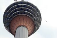 Someone BASE jumps off Malaysia's Kuala Lumpur Tower during KL Tower International Jump on Sept. 27.