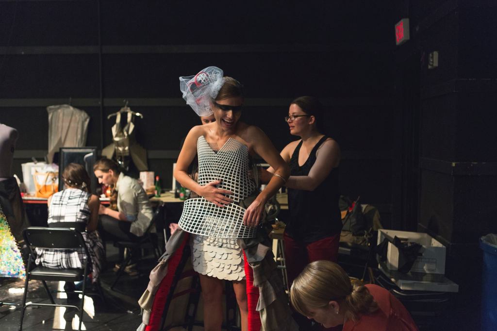 The team from McLean, Va.-based Davis Carter Scott preps Kristen Melton before the show. The firm's used the back of a Herman Miller chair for the John Tyler-inspired dress.
