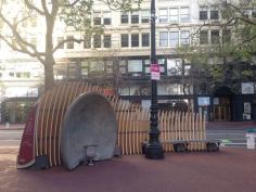 Two concrete bandstands face off one another across a plaza, allowing people seated inside them to hear each other across the way.
