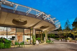 The+Discovery+Center+is+earth+bermed+and+features+passive+cooling%2c+large+overhangs+to+admit+natural+light+without+the+heating+effects+of+direct+light.+The+Texas+Skywalk+is+visible+in+the+background.