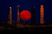 The moon over the Cuatro Torres Business Area in Madrid, Spain, on Monday.