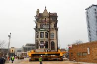 Crews watch as the Harriet F. Rees House, built in 1888, is slowly moved 600-feet to its new location.