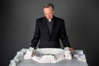 Rev. John I. Jenkins, the university's president, looks at a model of the project.