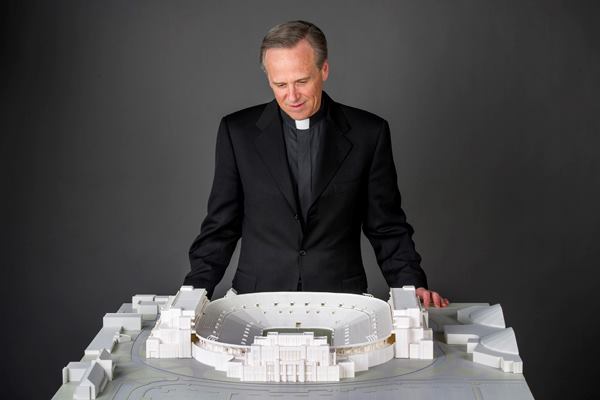 Rev. John I. Jenkins, the university's president, looks at a model of the project.