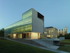 An exterior view at dusk of the new Steven L. Anderson Design Center and Vol Walker Hall in the background.
