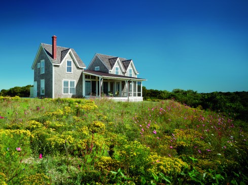 The residence incorporates two architectural features common to the island: the “Block Island Dormer”, where the building facade is extended into the roof with a gable, and the shed porch. Expanding on the two, the front porch became more than an applied form, it became a connector between two blocks.