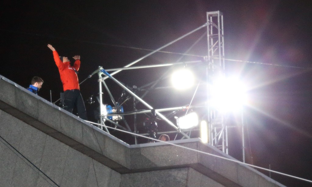 Nik Wallenda celebrates after walking a tightrope Sunday, Nov. 2, 2014 from Marina City to the Leo Burnett Building over the Chicago River. (Brian Cassella/Chicago Tribune)