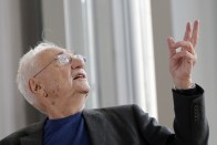 American architect Frank Gehry, center, speaks to journalists during the press day at his latest creation, the Louis Vuitton Foundation art museum and cultural center, in Paris, Friday, Oct. 17, 2014. The 100-million-euro building, with billowing glass casing and 11 gallery spaces, has been compared to an iceberg or giant sailboat and took over a decade to make. (AP Photo/Christophe Ena)