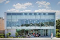 On a sunny day at the Glen Oaks branch library in New York, passersby can watch the word “search” emerge from the upper right corner of the parapet, enlarge to full height at noon, and then steadily disappear into the upper left corner.